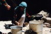 Afghanistan: Woman cooking outdoors - photo by Anne Dinnan