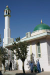 Afghanistan - Herat - women in burka passing a modern mosque - photo by E.Andersen