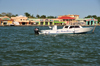 Belize City, Belize: boat used in San Pedro-Belize express service - shops and bars of Belize City Tourism Village and Radisson Fort George - mouth of Haulover Creek - photo by M.Torres