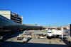 So Paulo, Brazil: groundcrew servicing an airliner parked at a jet bridge at So Paulo / Guarulhos International Airport - aka GRU Airport and Governador Andr Franco Montoro International Airport - terminal building on a sunny day - photo by M.Torres