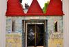 Cameroon, Douala: western gate at the Mukanda Palace, Chteau Mukanda - red roof and ethnic Bamilk ornamentation - Le Chteau de Bonambela - photo by M.Torres