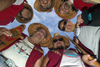 Vancouver, BC, Canada: group of North American Indians with smiling faces and wearing tradional native dress and ceremonial hats in a circle looking down at camera - Squamishnation ceremony in West Vancouver - photo by D.Smith