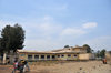 Goma, Nord-Kivu, Democratic Republic of the Congo: biker in front of an old colonial school building - photo by M.Torres