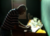 Cuba - Guardalavaca - man writes a thoughtful letter in the late afternoon - Emilio - photo by G.Friedman