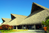 Punta Cana, Dominican Republic: thatched roofs of terminal - air side - Punta Cana International Airport - PUJ / MDPC - photo by M.Torres