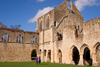 Netley, Hampshire, South East England, UK: Netley Abbey - couple holding hands walking towards ruins - cloister showing the south transept of the church and the east range - photo by I.Middleton