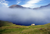 Srvgsfjrur fjord, Vgar island, Faroes: fog and cottage on the cliff edge - photo by A.Ferrari