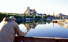 Auxerre, Yonne, Burgundy / Bourgogne, France: angler trying his luck on the river - view of the town from the Paul Bert bridge - Auxerre cathedral and Abbaye Saint-Germain d'Auxerre - photo by K.Gapys