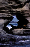 Santiago Island, Galapagos Islands, Ecuador: Sea Lions (Zalophus californianus) framed by rocks in James Bay - rock window - photo by C.Lovell