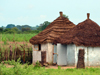 Fass, North Bank division, Gambia: rural area - village huts with thatched roofs and corrugated metal doors - photo by M.Torres