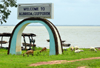 Albreda, Gambia: goats and arch with a view of the Gambia River - Albreda / Juffureh welcome arch - photo by M.Torres