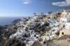 Greece, Cyclades, Santorini:the village of Oia perches atop a clifftop overlooking the Aegean Sea - photo by P.Hellander