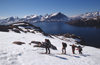 Greenland, Apussuit: skiers climbing steep snow slope - photo by S.Egeberg