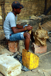 Bissau, Guinea Bissau / Guin Bissau: Cho de Papel Varela quarter, Carnival masks, man sculpting a mask of a dragon / Bairro Cho de Papel Varela, mscaras de Carnaval, preparao, homem a esculpir uma mscara de um drago - photo by R.V.Lopes