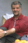 Iran: a fruit merchant sits by his stall - photo by W.Allgower