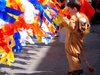 Israel: toddler dressed-up for Purim celebrations, playing with colored stripes - photo by E.Keren