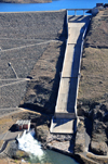 Mohale Dam, Lesotho: the spillway is an ungated concrete lined chute with ogee weir and flip bucket at the bottom - it is used to provide the controlled release of flows - overflow channel - photo by M.Torres