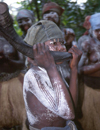 Grand Bassa County, Liberia, West Africa: secret society girls - musician playing a horn - African music - photo by M.Sturges