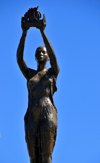 Toamasina / Tamatave, Atsinanana region, Madagascar: monument on Independence avenue - woman holding a vessel - the city has a long tradition in sea trade - Araben'ny Fahaleovantena blvd - photo by M.Torres