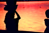 Mali - Segou: evening arrives - women silhouettes against the water - photo by by N.Cabana