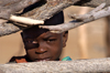 Namibia: Himba Boy peering through fence, Skeleton Coast, Kunene region - photo by B.Cain