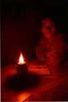 Nepal - Annapurna region: portrait by candlelight - photo by G.Friedman