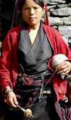 Nepal - Langtang region - woman spinning yak wool - photo by E.Petitalot