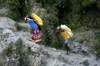 Nepal - Pokhara: day labourers transport bags uphill - photo by W.Allgwer