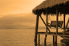 Panama - Bocas del Toro - Palm roofed dock - hanging bench - photo by H.Olarte