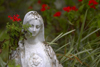 Panama - Cerro Azul: run down statue of the Virgin Mary surrounded by red flowers stands at the entrance of a Catholic home - photo by H.Olarte