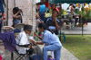 A woman feeds an old man - in the Panamanian tradition, the elders are cared for by the younger relatives - Portobello, Coln, Panama - photo by H.Olarte