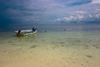 Alona Beach, Bohol island, Central Visayas, Philippines: lone boat moored by the beach with storm clouds in the background - photo by S.Egeberg