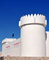 Doha, Qatar: Kuwt / Khoot / Koot fort, established by the Ottoman Empire in 1880 - white towers and ramparts - western wall, on Al Asmakh Street - photo by M.Torres