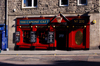 Scotland - Edinburgh: This clever sign is a takeoff on the nearby street Canongate- vibrant colors in the storefront - photo by C.McEachern