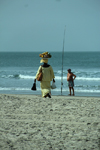 Cap Skirring, Oussouye, Basse Casamance (Ziguinchor), Senegal: Woman Walking on the beach to sell fruits and a man fishing, everyday life / Mulher caminhando na praia para vender frutas e homem a pescar, vida quotidiana - photo by R.V.Lopes