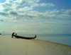 Turtle Islands, Southern Province, Sierra Leone: fishermen and small fishing canoe on the beach - photo by T.Trenchard