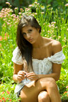 young Arab woman sitting in a glamorous fashion pose in a garden setting. Model is Aida Maleki of Portland, Oregon. Photographed at the Park and Tilford Gardens. North Vancouver, BC, Canada.  Model and property released. - photo by D.Smith