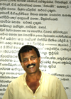 Matara, Southern province, Sri Lanka: temple - guide with Sinhalese text in the background - photo by B.Cain