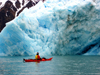 Svalbard - Spitsbergen island: kayaking guide, Judd Hill, observes an enormous iceberg carved from the 14 July galcier - photo by R.Eime