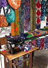 Lom, Togo: SInger sewing machine and colorful fabrics - local fashion studio - photo by G.Frysinger